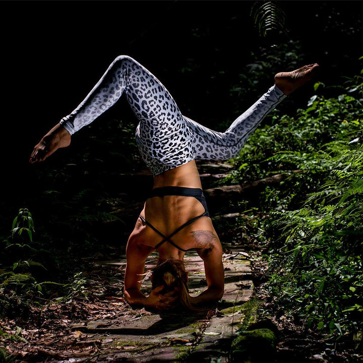 Headstand in white leopard leggings by Yoga Hero